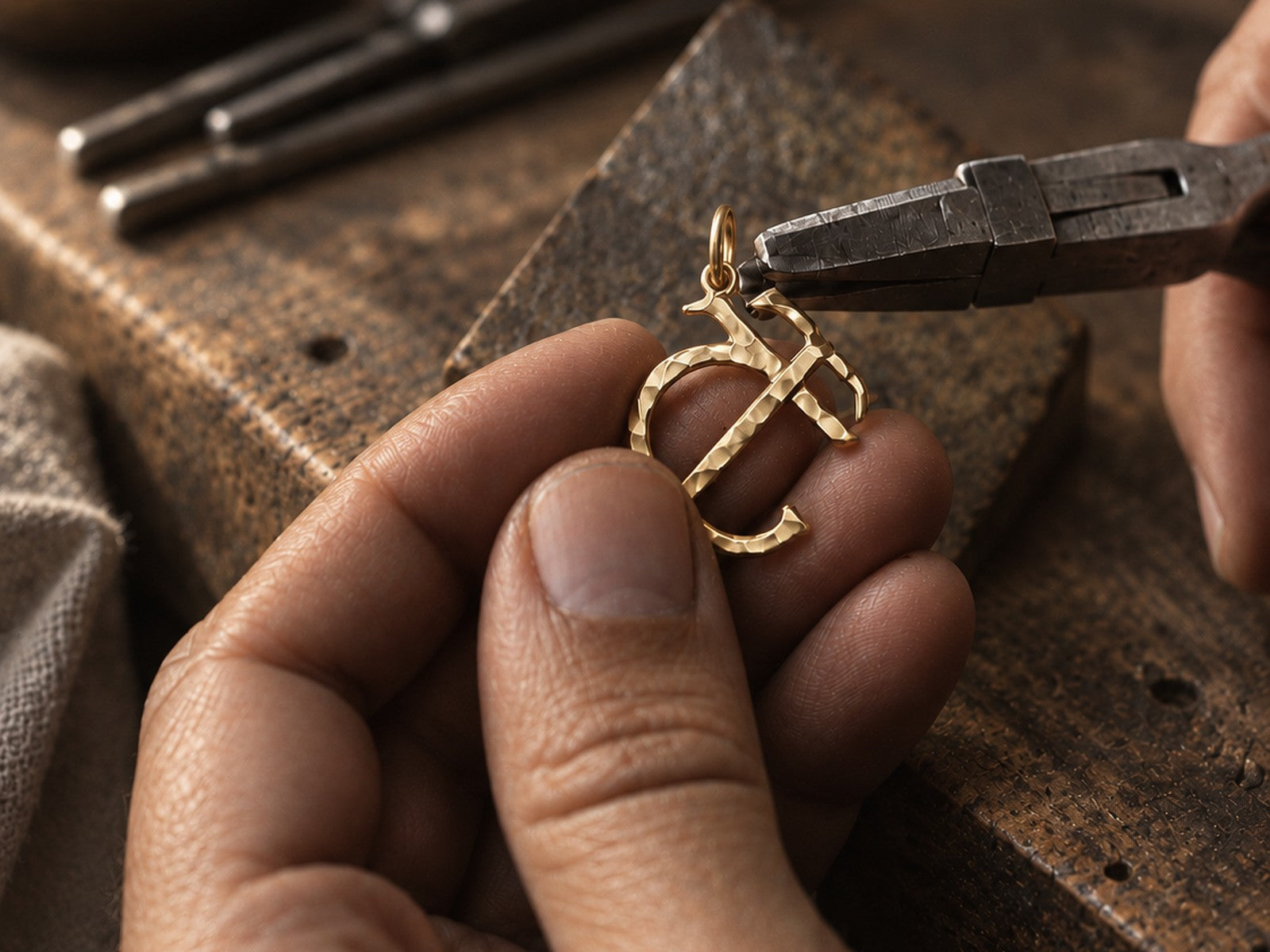 A ligature pendant held in the hand at the bench