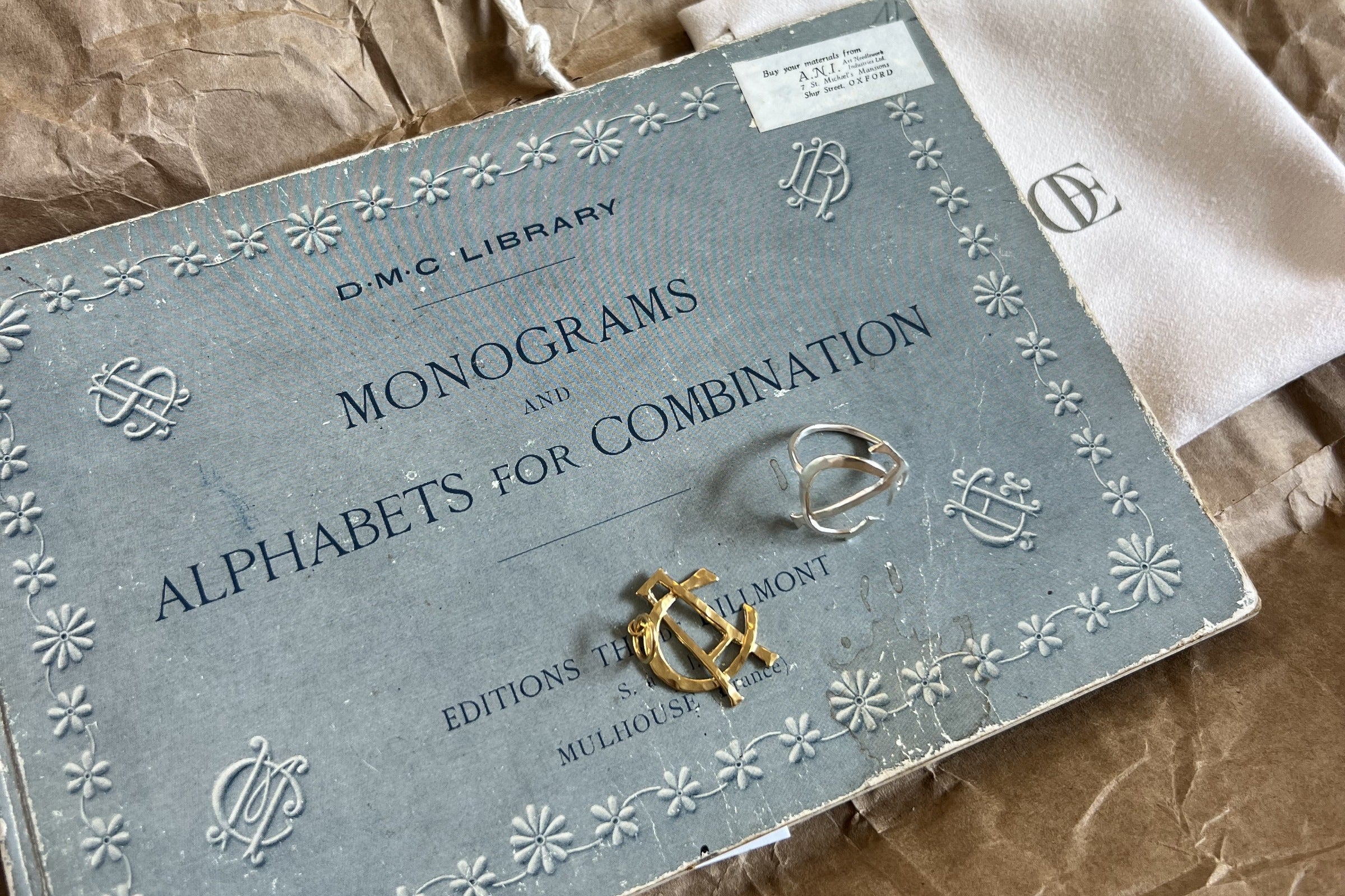 An old book of monograms, open on the desk